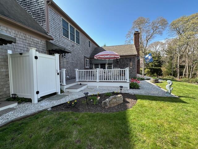 30 Monomessat Way, Chatham, MA 02633 - back of property featuring a deck, a yard, and a chimney