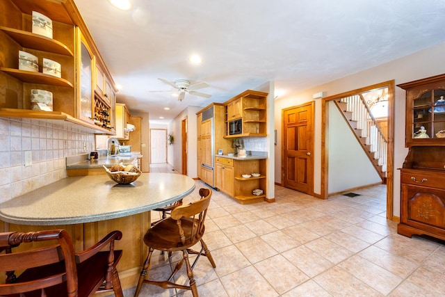 30 Monomessat Way, Chatham, MA 02633 - kitchen featuring open shelves, decorative backsplash, a breakfast bar, black microwave, and recessed lighting