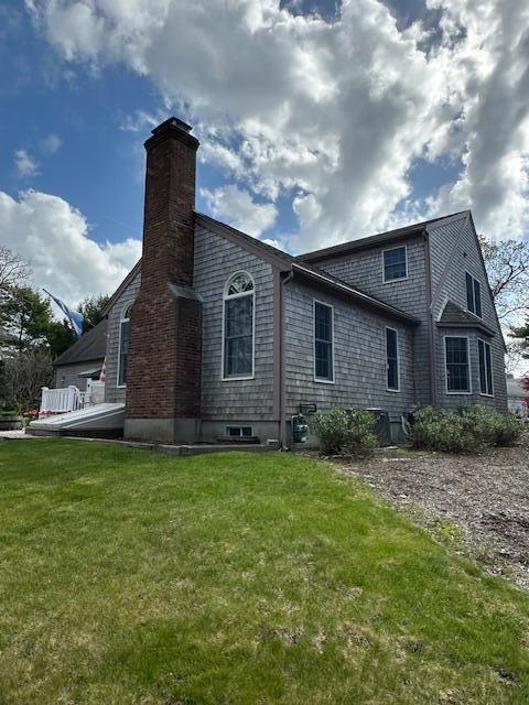 30 Monomessat Way, Chatham, MA 02633 - rear view of house with a yard and a chimney