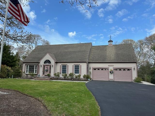 30 Monomessat Way, Chatham, MA 02633 - view of front of home featuring an attached garage, asphalt driveway, a front lawn, and a chimney