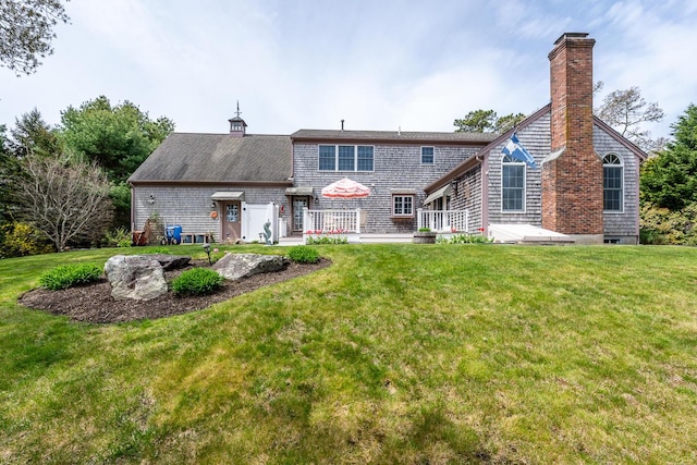 30 Monomessat Way, Chatham, MA 02633 - back of house with a chimney, a lawn, and a wooden deck