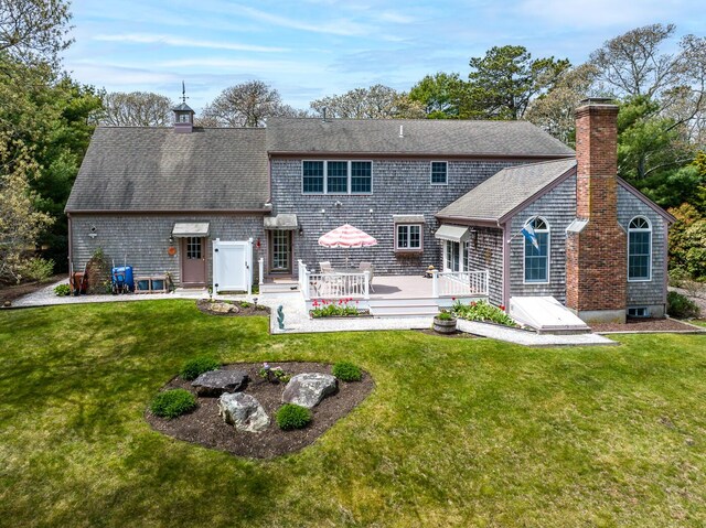 30 Monomessat Way, Chatham, MA 02633 - back of property with a chimney, a yard, and a shingled roof