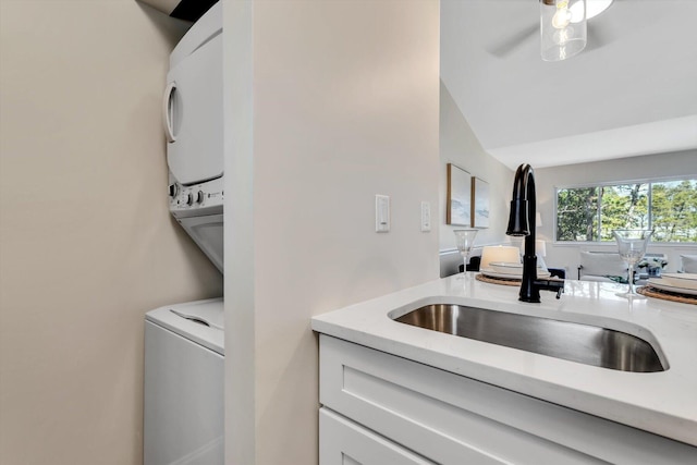 laundry room with stacked washer / drying machine