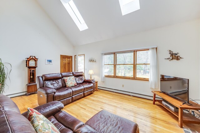 79 Pinewood Cir, Wellfleet, MA 02667 - living area featuring high vaulted ceiling, light wood-type flooring, a skylight, and a baseboard radiator