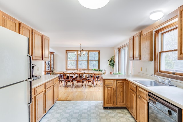 79 Pinewood Cir, Wellfleet, MA 02667 - kitchen with light countertops, a sink, freestanding refrigerator, light floors, and dishwasher