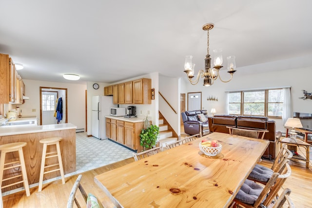 79 Pinewood Cir, Wellfleet, MA 02667 - dining space featuring a wealth of natural light, a baseboard heating unit, stairway, and light wood-type flooring