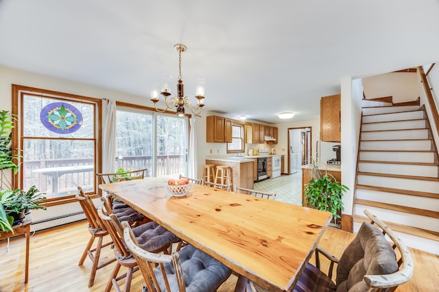 79 Pinewood Cir, Wellfleet, MA 02667 - dining area featuring an inviting chandelier, stairway, and light wood-type flooring