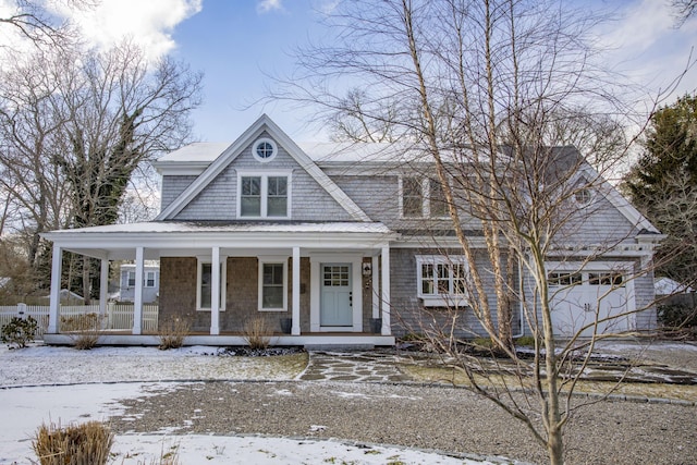 view of front of house featuring a porch and a garage