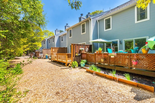 rear view of property featuring a deck