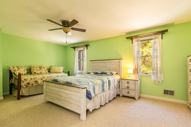 carpeted bedroom with baseboards and ceiling fan