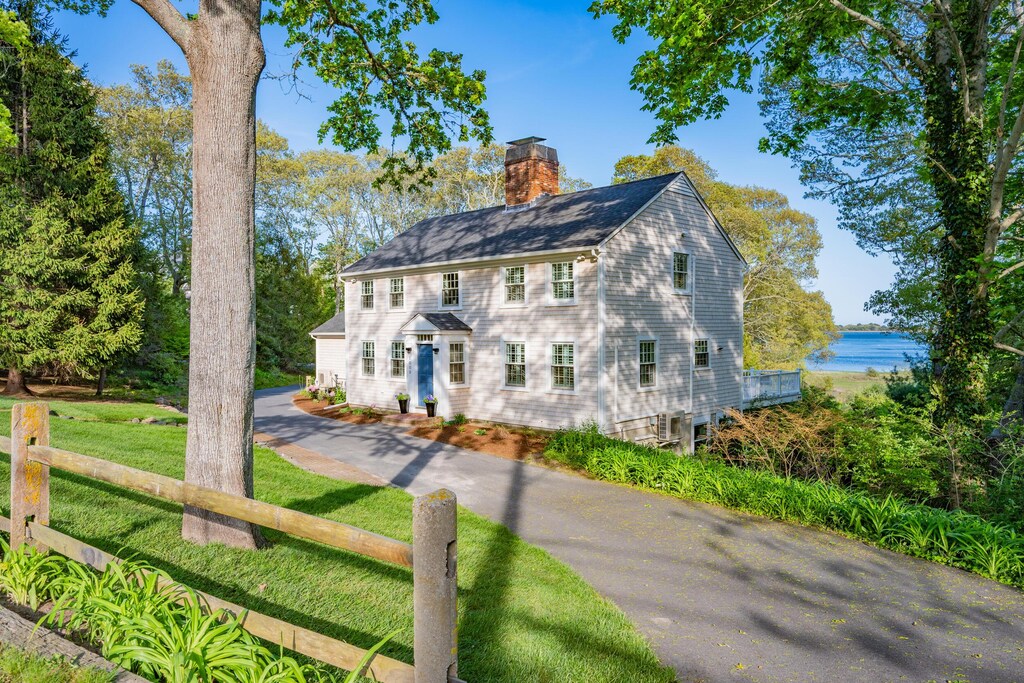 1000 Main St, Cotuit, MA 02635 - colonial house featuring a chimney and a water view