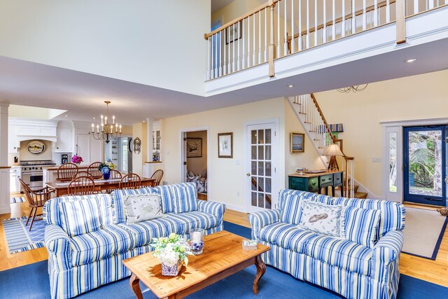 86 Champlain Rd, Chatham, MA 02633 - living room with a chandelier, wood finished floors, and a towering ceiling