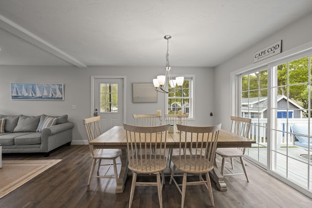57 Melgo Ln, South Yarmouth, MA 02664 - dining area featuring a chandelier, dark wood-type flooring, and baseboards