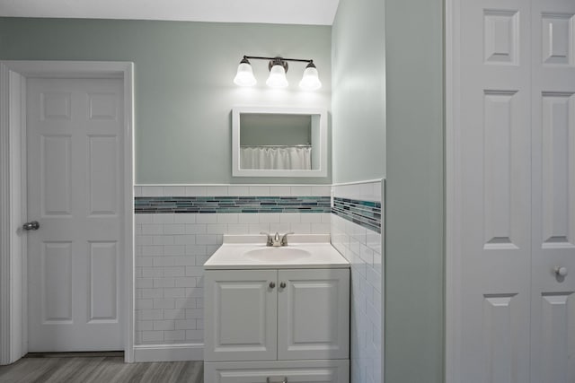 57 Melgo Ln, South Yarmouth, MA 02664 - full bath featuring tile walls, vanity, wood finished floors, a closet, and wainscoting
