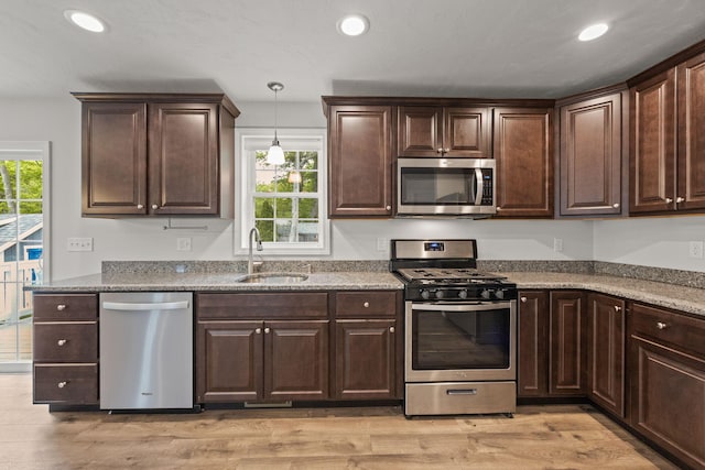 57 Melgo Ln, South Yarmouth, MA 02664 - kitchen with stainless steel appliances, a sink, dark brown cabinets, recessed lighting, and light wood-style flooring