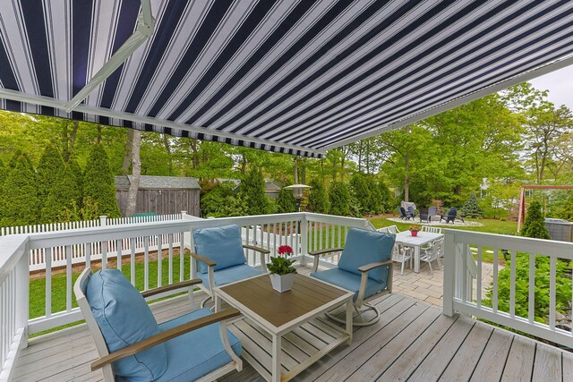 57 Melgo Ln, South Yarmouth, MA 02664 - wooden deck featuring outdoor dining area and view of scattered trees
