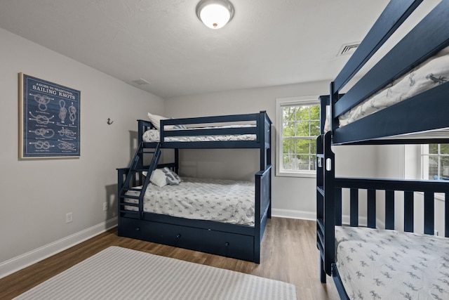 57 Melgo Ln, South Yarmouth, MA 02664 - bedroom featuring baseboards and wood finished floors