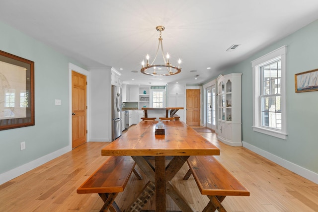 dining area featuring a chandelier, light wood-type flooring, baseboards, and recessed lighting