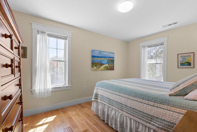 bedroom with baseboards and light wood-style floors