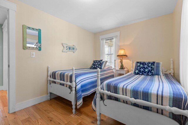 bedroom with light wood-style floors and baseboards