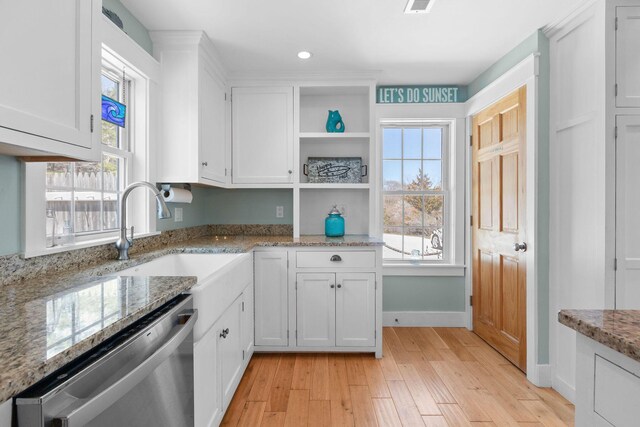 kitchen with stainless steel dishwasher, light wood-type flooring, white cabinets, healthy amount of natural light, and recessed lighting