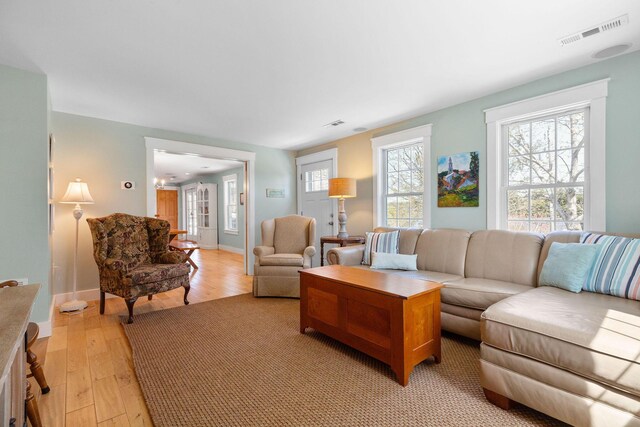 living room featuring light wood finished floors and baseboards