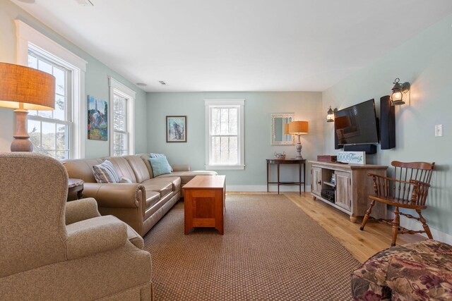 living room with light wood-style flooring and baseboards