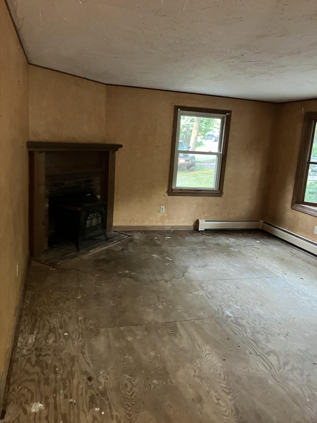 1094 County Rd, Pocasset, MA 02559 - unfurnished living room with healthy amount of natural light, a textured ceiling, and a wood stove