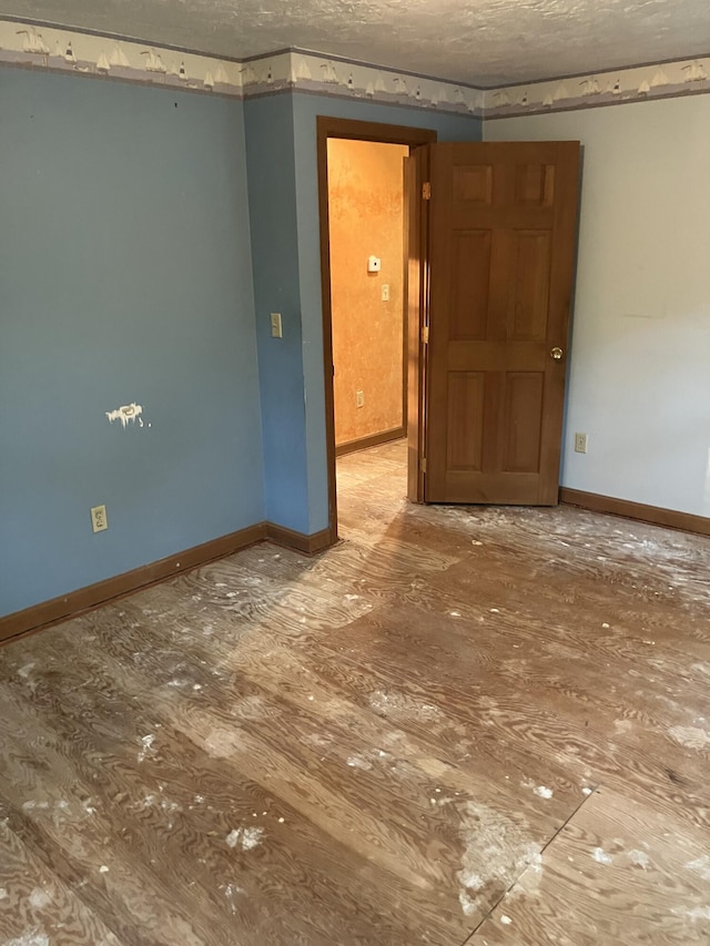 1094 County Rd, Pocasset, MA 02559 - spare room featuring baseboards and a textured ceiling