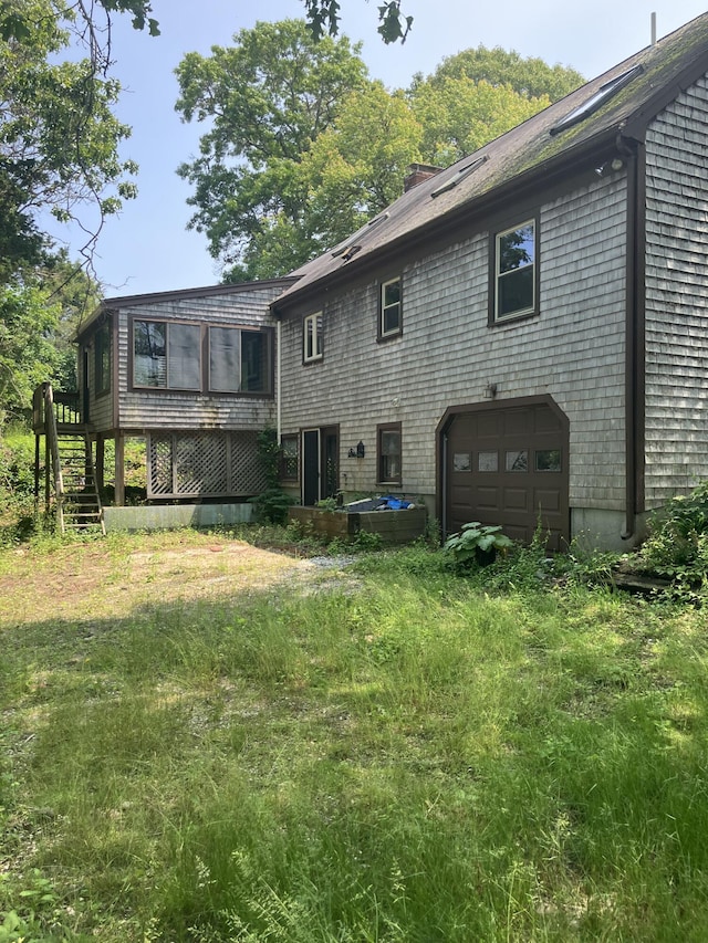 1094 County Rd, Pocasset, MA 02559 - back of property featuring a garage, stairs, and a chimney
