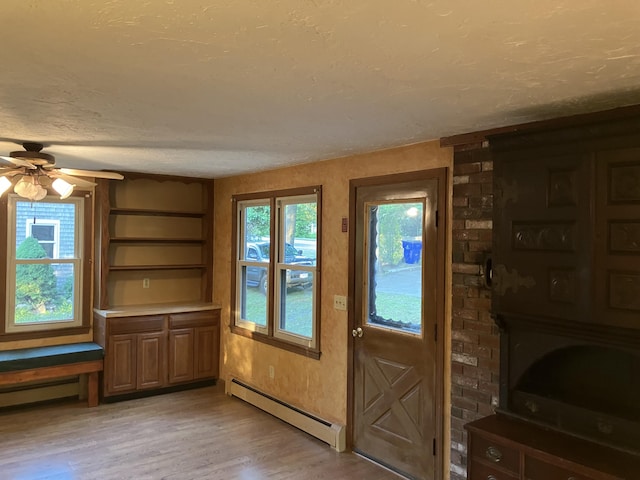 1094 County Rd, Pocasset, MA 02559 - entryway with a baseboard heating unit, light wood-style floors, ceiling fan, and a textured ceiling