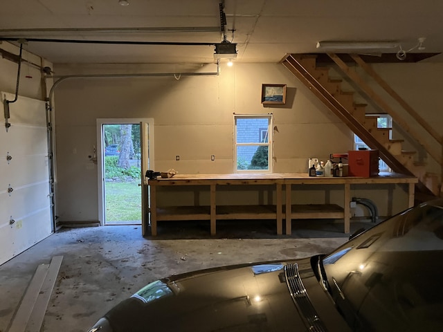 1094 County Rd, Pocasset, MA 02559 - garage featuring a garage door opener and a workshop area