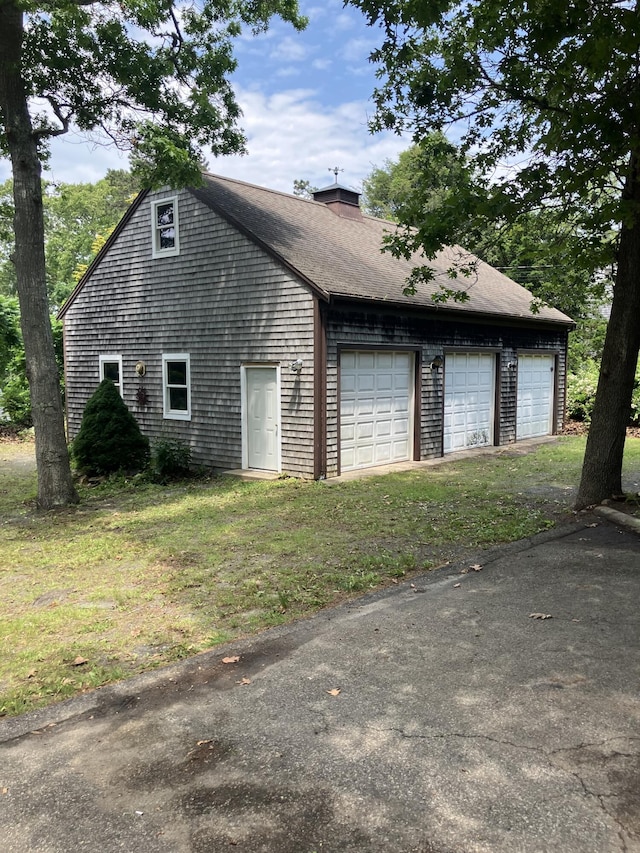 1094 County Rd, Pocasset, MA 02559 - view of side of property featuring a chimney, a yard, and a garage