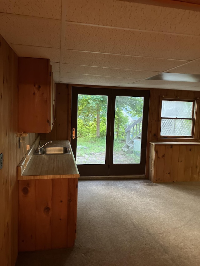 1094 County Rd, Pocasset, MA 02559 - kitchen with light colored carpet, healthy amount of natural light, wood walls, and a paneled ceiling