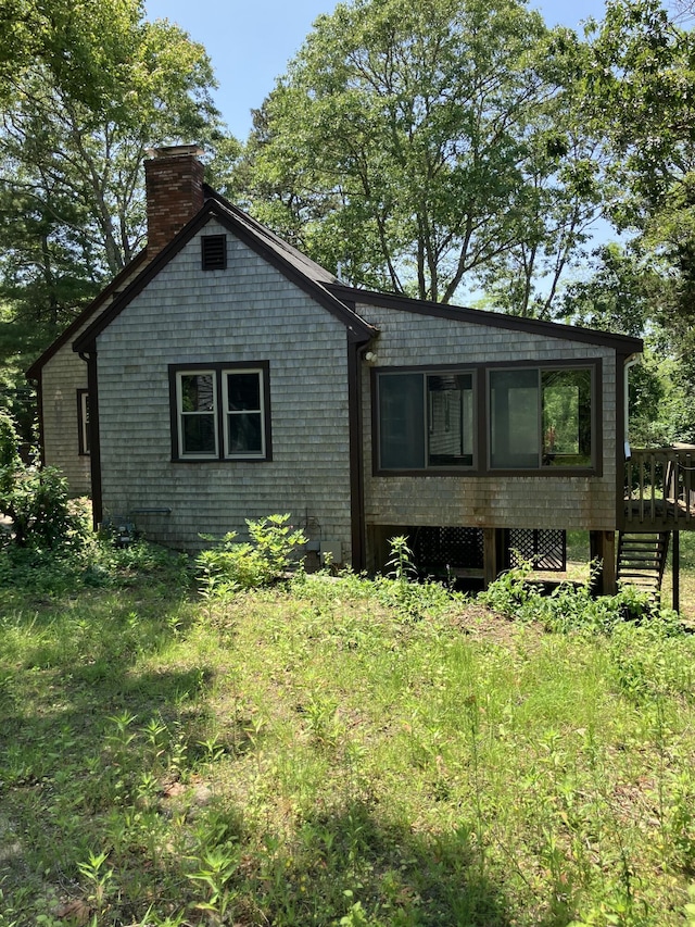 1094 County Rd, Pocasset, MA 02559 - view of front facade with a chimney and a wooden deck