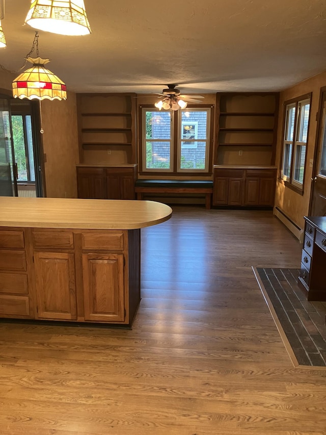 1094 County Rd, Pocasset, MA 02559 - kitchen featuring open shelves, baseboard heating, a ceiling fan, light countertops, and wood finished floors