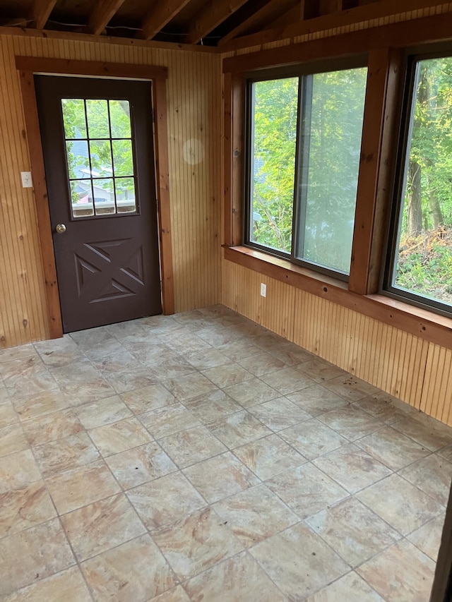 1094 County Rd, Pocasset, MA 02559 - entryway featuring healthy amount of natural light, wooden walls, and light stone finish floors