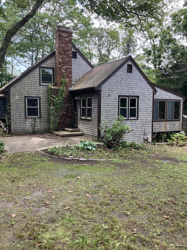 1094 County Rd, Pocasset, MA 02559 - rear view of house featuring a chimney and a shingled roof
