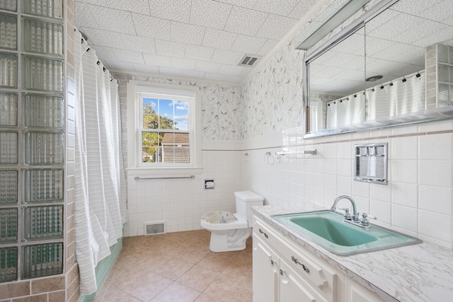 175 Lower County Rd, West Harwich, MA 02671 - bathroom with vanity, tile walls, tile patterned flooring, toilet, and a shower with shower curtain
