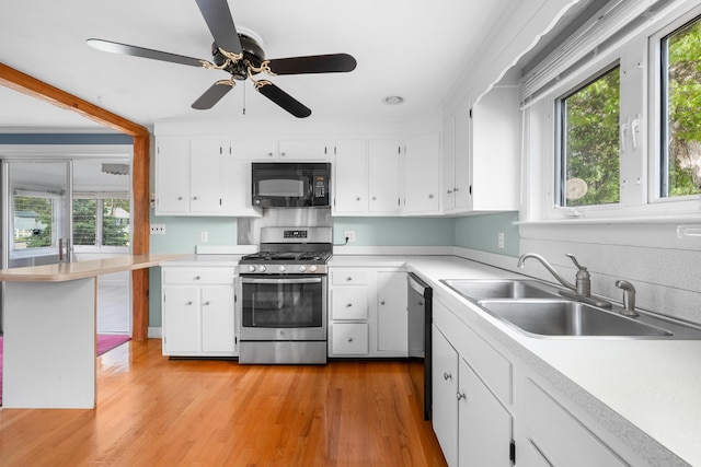 175 Lower County Rd, West Harwich, MA 02671 - kitchen with black microwave, gas range, a sink, and plenty of natural light