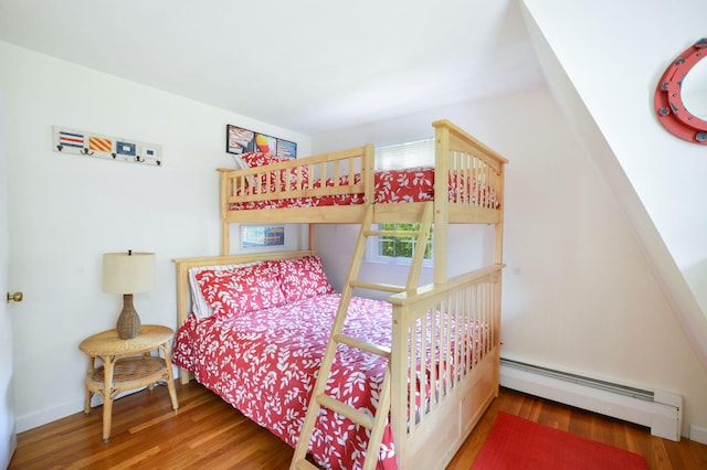110 Teaticket Path, East Falmouth, MA 02536 - bedroom with a baseboard heating unit and wood finished floors