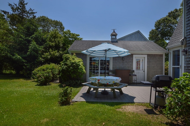 110 Teaticket Path, East Falmouth, MA 02536 - back of house with a wooden deck, a lawn, a shingled roof, and outdoor dining area