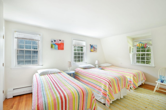 110 Teaticket Path, East Falmouth, MA 02536 - bedroom with a baseboard heating unit and wood finished floors