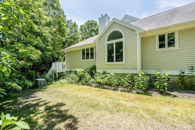 37 Pine Hill Blvd, Mashpee, MA 02649 - view of side of property with a yard, a chimney, a shingled roof, and a deck