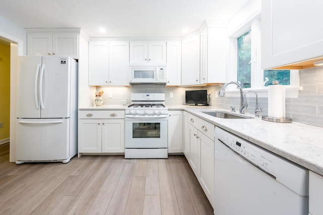 37 Pine Hill Blvd, Mashpee, MA 02649 - kitchen featuring white appliances, white cabinets, light wood-style floors, tasteful backsplash, and recessed lighting