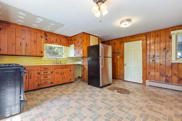 22 Browne St, Provincetown, MA 02657 - kitchen featuring freestanding refrigerator, black range, wood walls, brick patterned floors, and light countertops