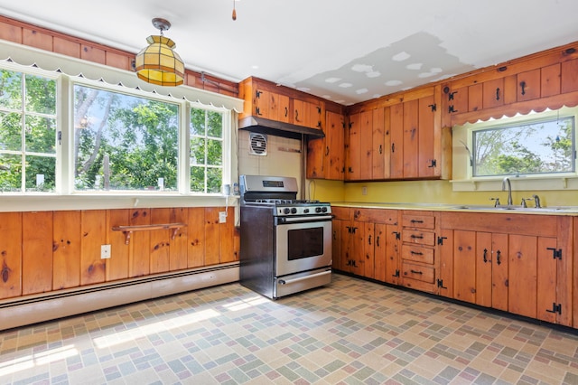 22 Browne St, Provincetown, MA 02657 - kitchen with stainless steel range with gas cooktop, a sink, light countertops, baseboard heating, and brown cabinetry