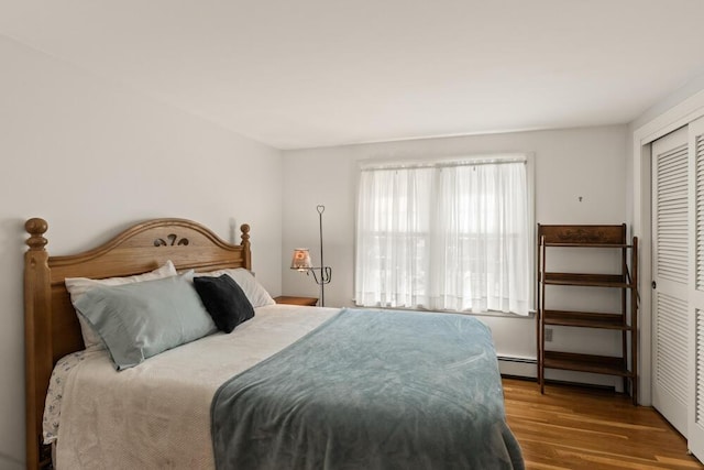 56 Fairwood Rd, South Yarmouth, MA 02664 - bedroom with a baseboard heating unit, wood finished floors, and a closet