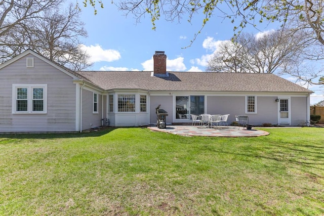 56 Fairwood Rd, South Yarmouth, MA 02664 - back of house with a lawn, a patio, a chimney, and a shingled roof