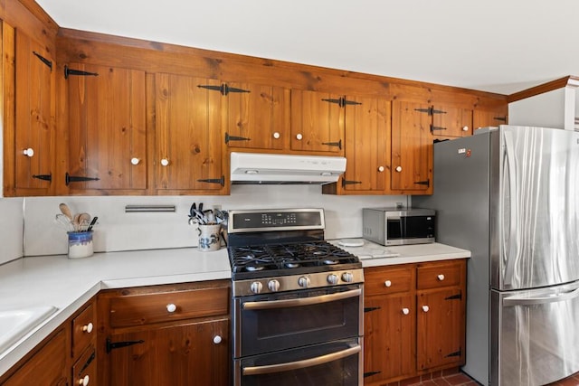 56 Fairwood Rd, South Yarmouth, MA 02664 - kitchen with light countertops, brown cabinetry, appliances with stainless steel finishes, and under cabinet range hood